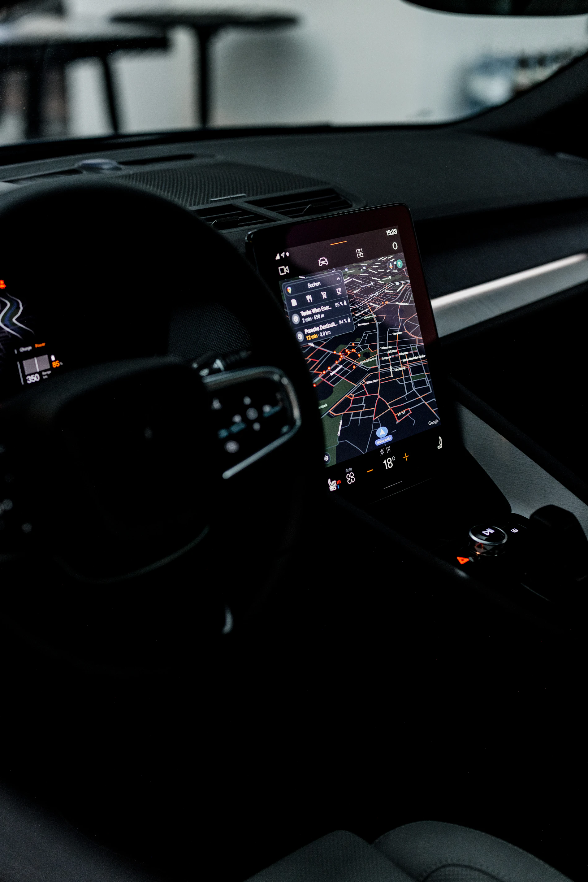 Vehicle dashboard with GPS navigation display and connected automotive electronics