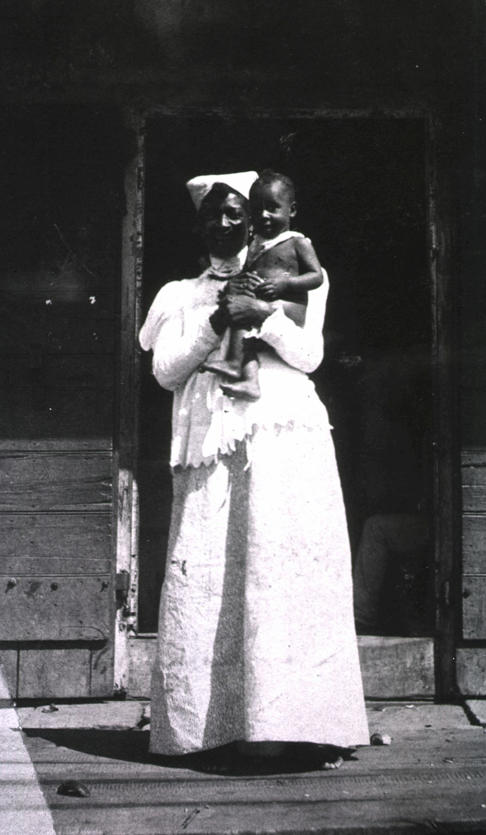 a black and white photo of a woman holding a child