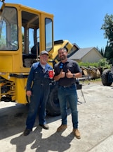 A friendly contractor shaking hands with a homeowner outside a sunny Miami house.