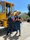 Image of a construction worker giving a thumbs up next to a concrete mixer truck.