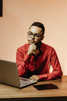 A cozy scene of a team member planning content on a parchment-colored desk with crimson accents.