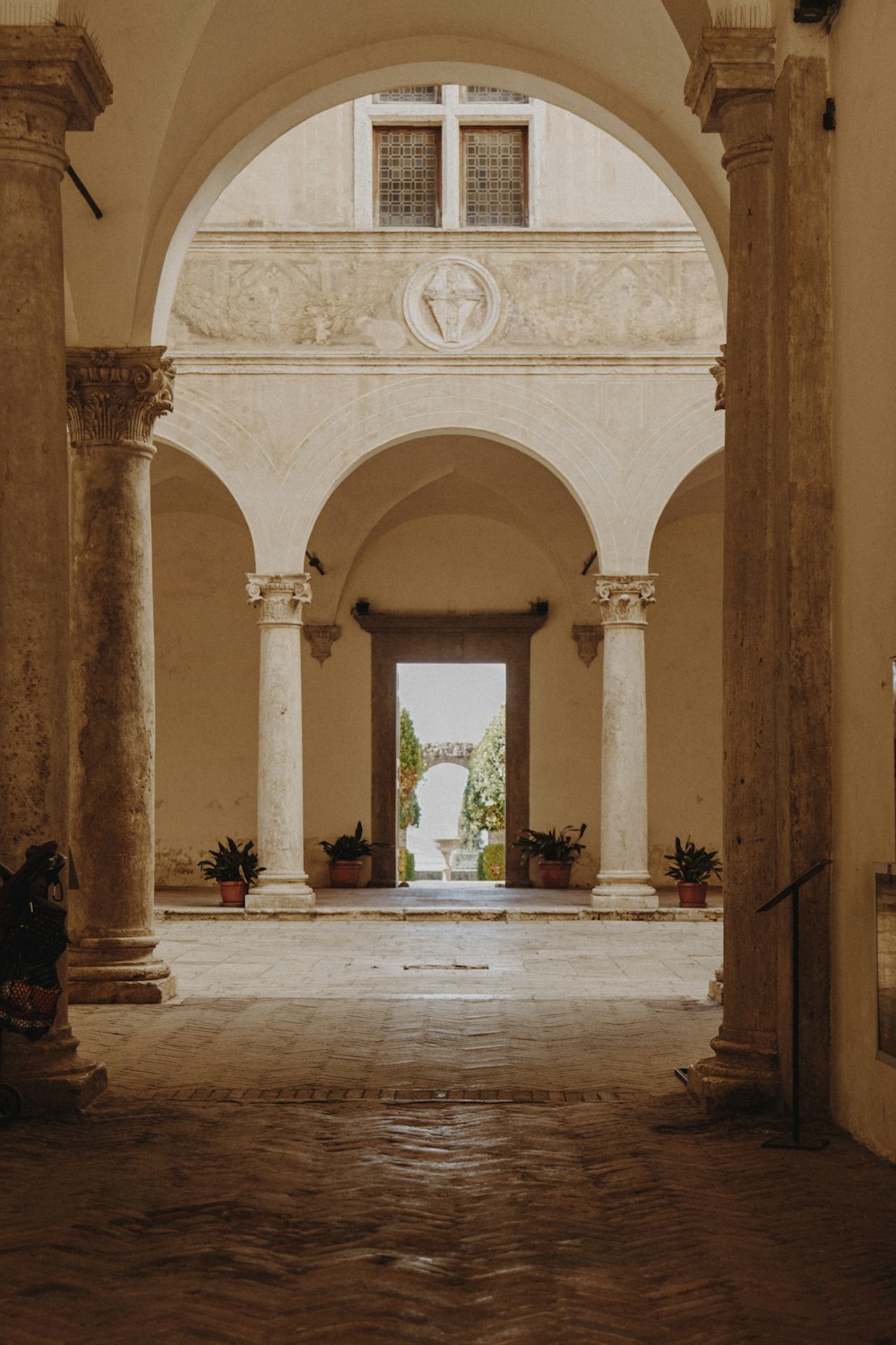 a hallway with columns and a clock on the wall