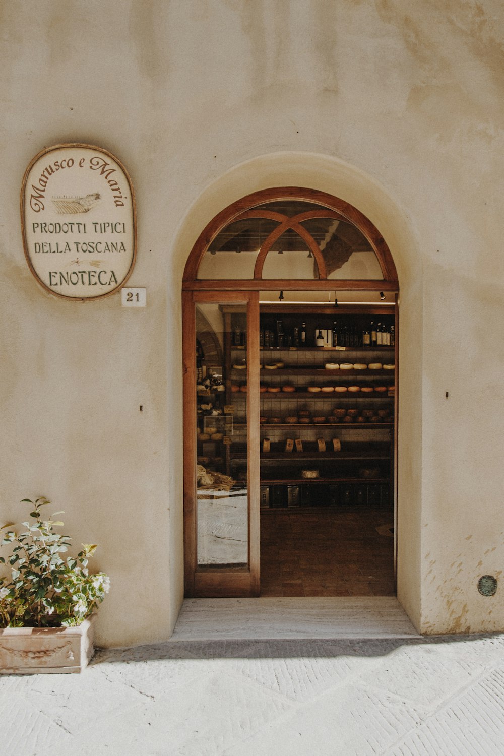 the entrance to a wine shop with a clock on the wall