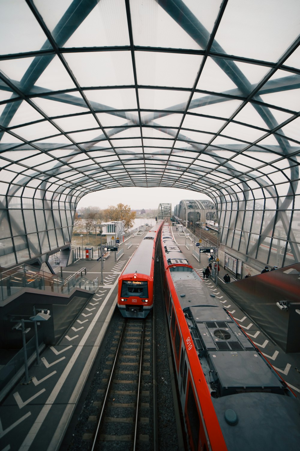 a red train traveling through a train station