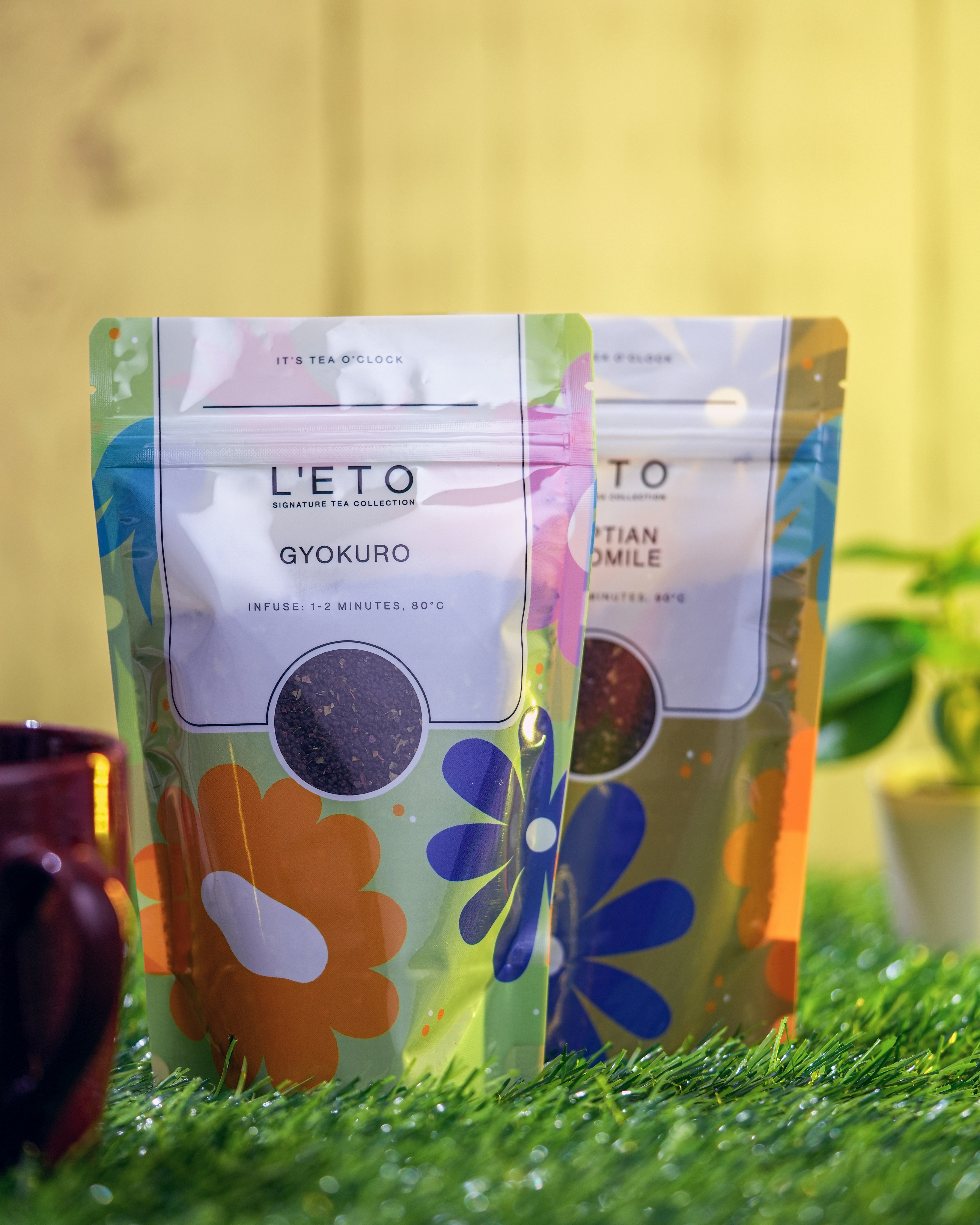 a couple of bags of coffee sitting on top of a green field