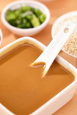 a bowl of soup with a spoon sticking out of it