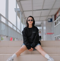 a woman sitting on the steps of a building