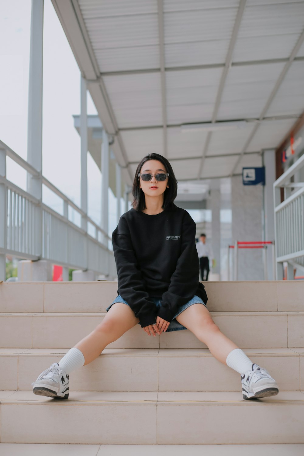 a woman sitting on the steps of a building