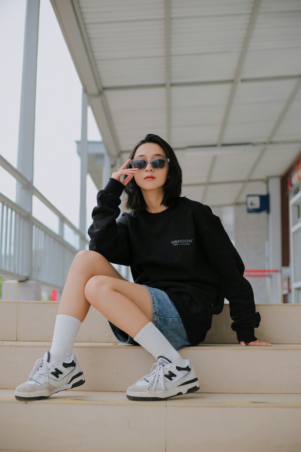 a woman sitting on steps with her legs crossed