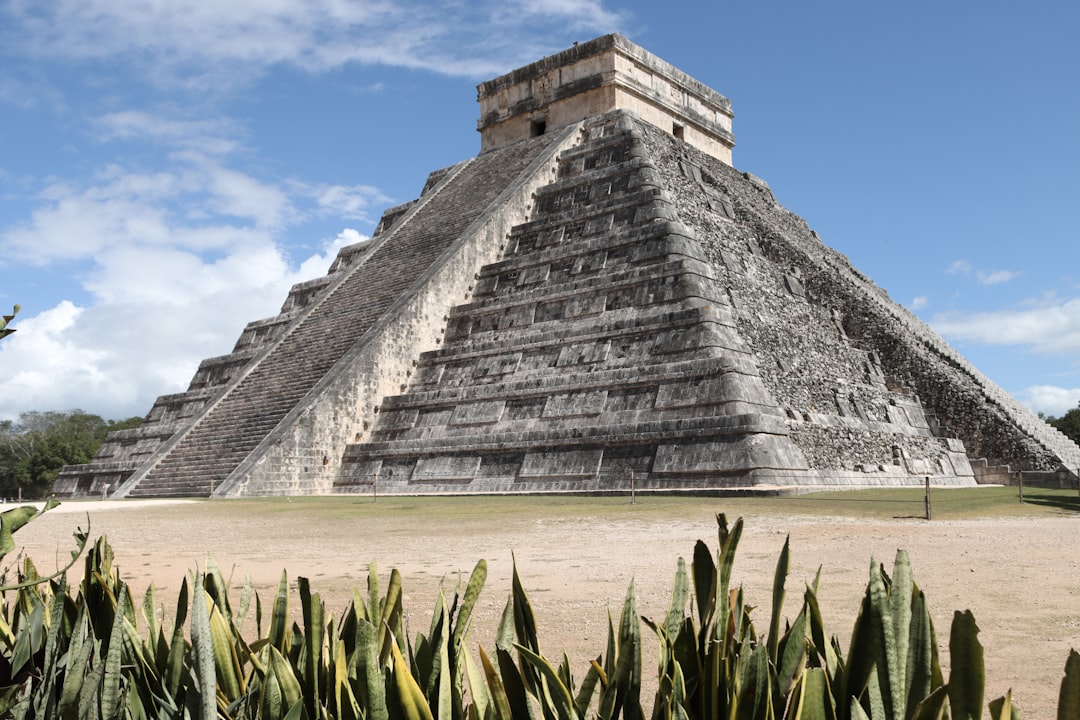 a very tall pyramid sitting in the middle of a field, El Castillio🇲🇽