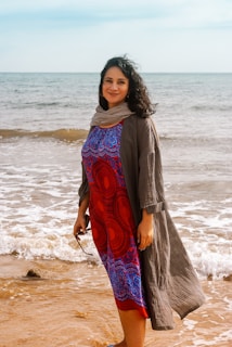 A serene coastal scene with a model dressed in a light, elegant Moroccan tunic inspired by seaside hues.