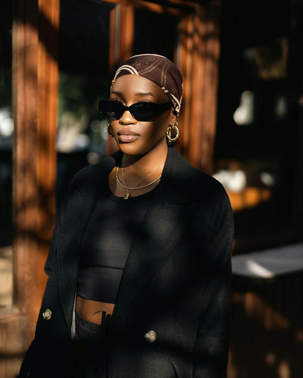 a woman wearing sunglasses and a head scarf