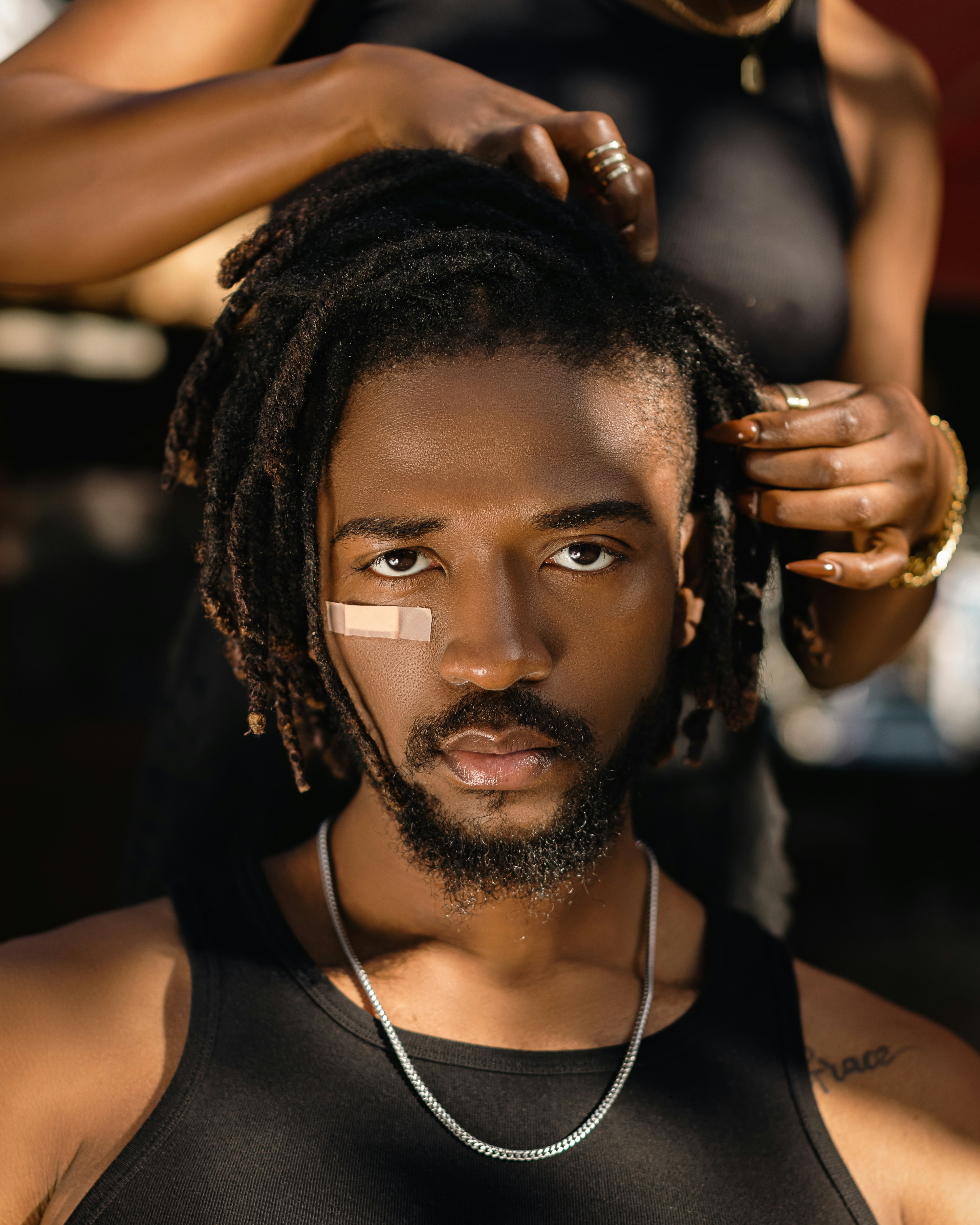 a man getting his hair cut by a woman