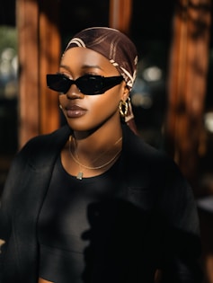 a woman wearing sunglasses and a head scarf