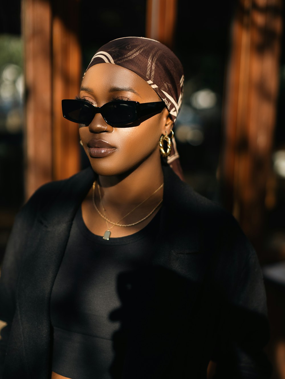 a woman wearing sunglasses and a head scarf
