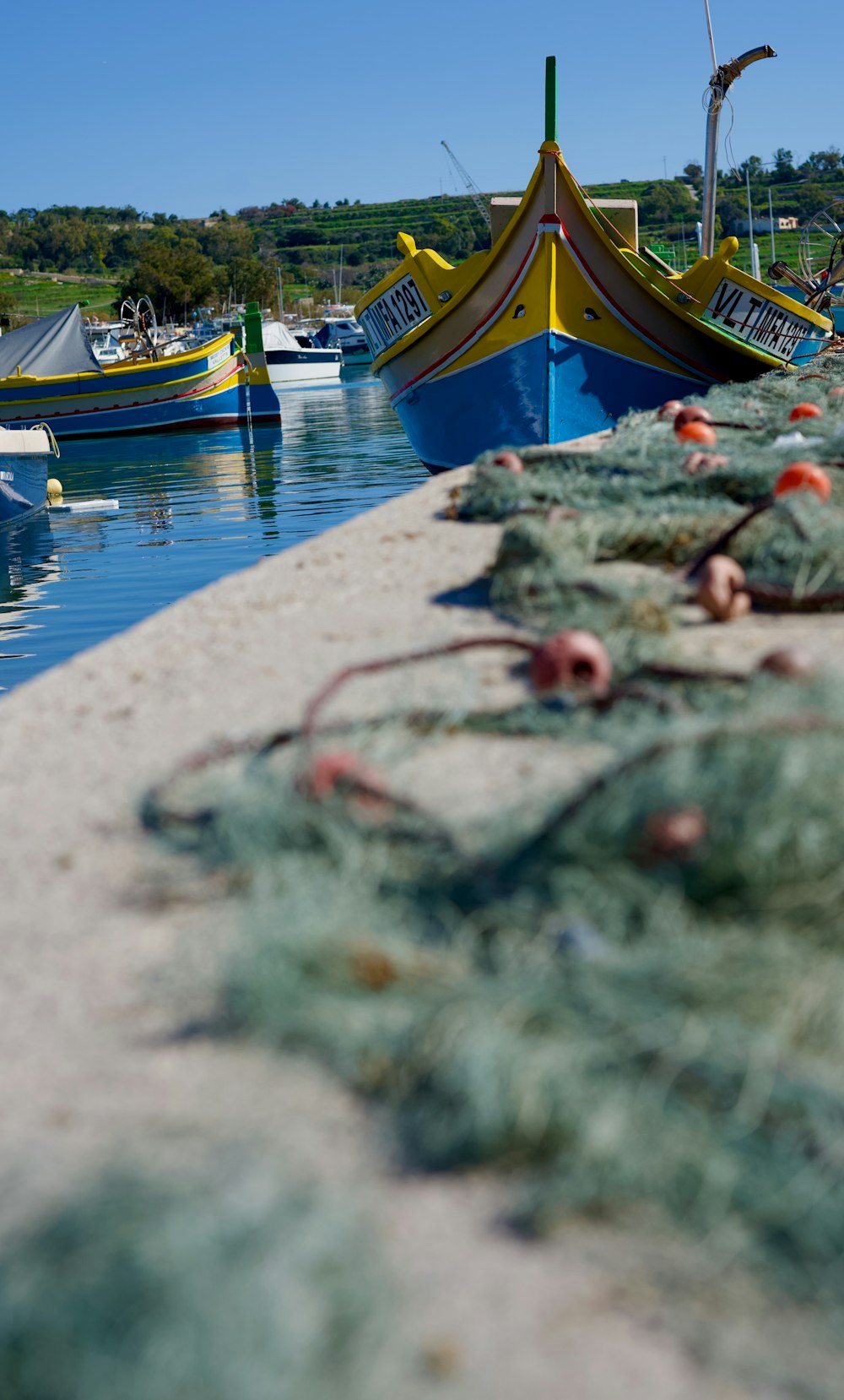 a row of boats sitting next to each other on a body of water