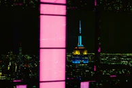 Nighttime cityscape highlighting a burgundy-lit commercial building developed by Burgundy Crest.