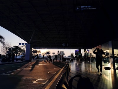 A busy airport terminal with travelers and airplanes visible outside.