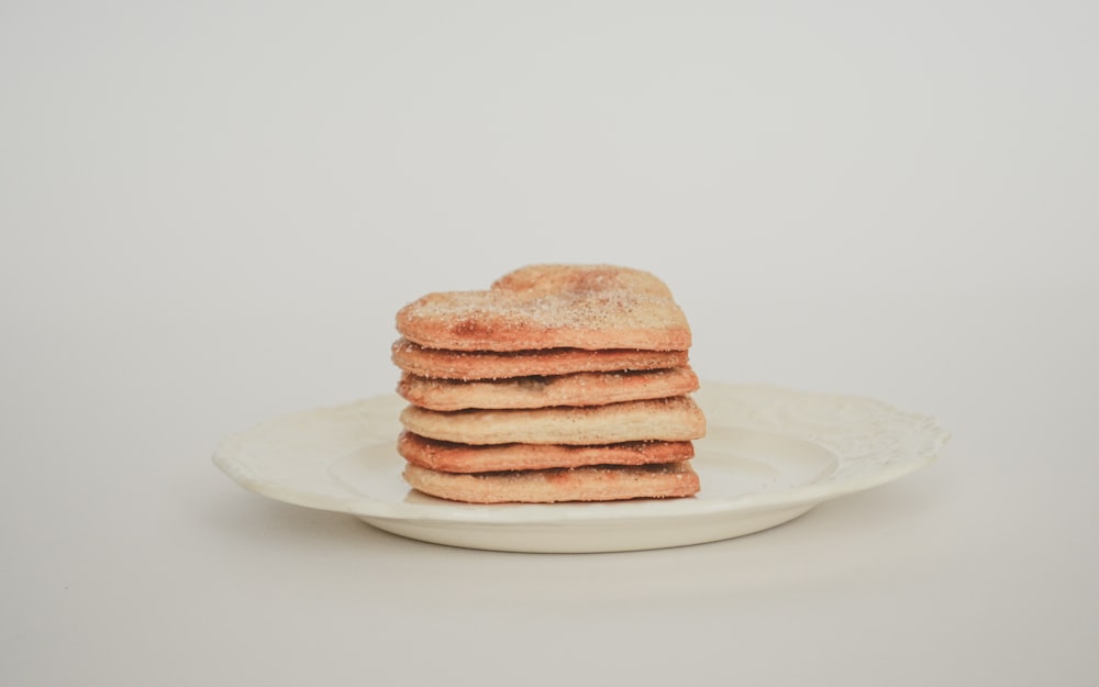 a stack of toasted bread on a white plate