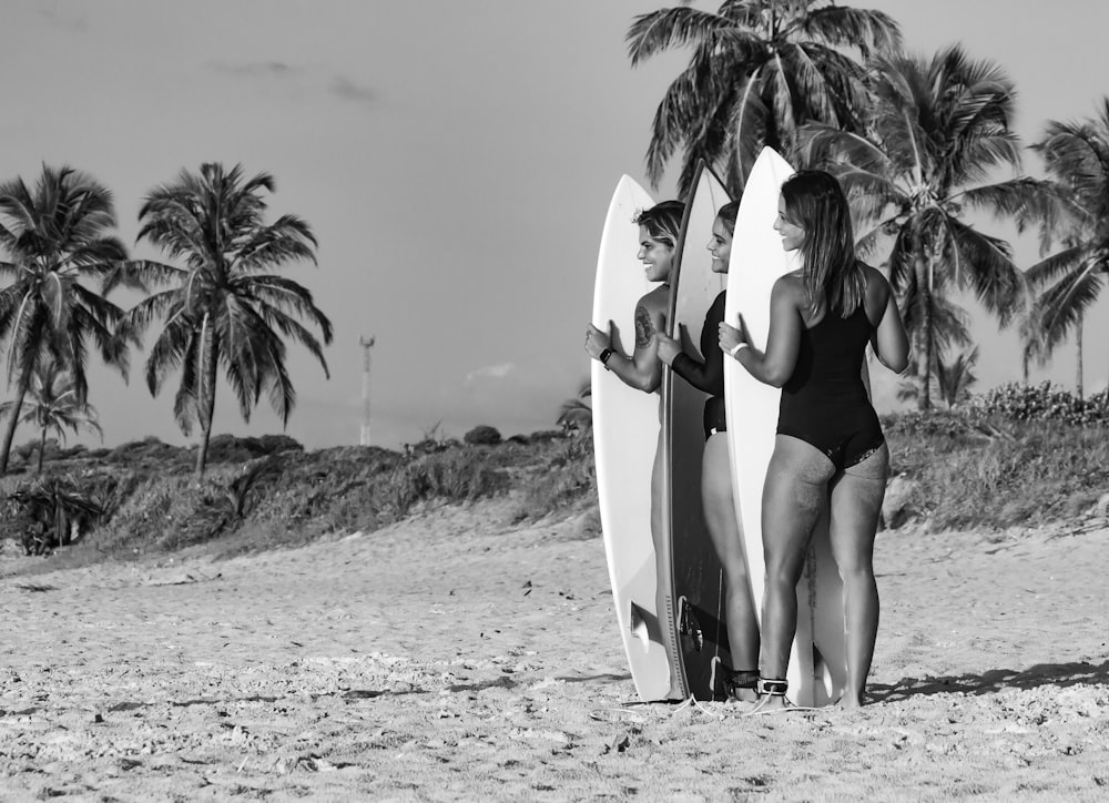 a couple of women standing next to each other on a beach