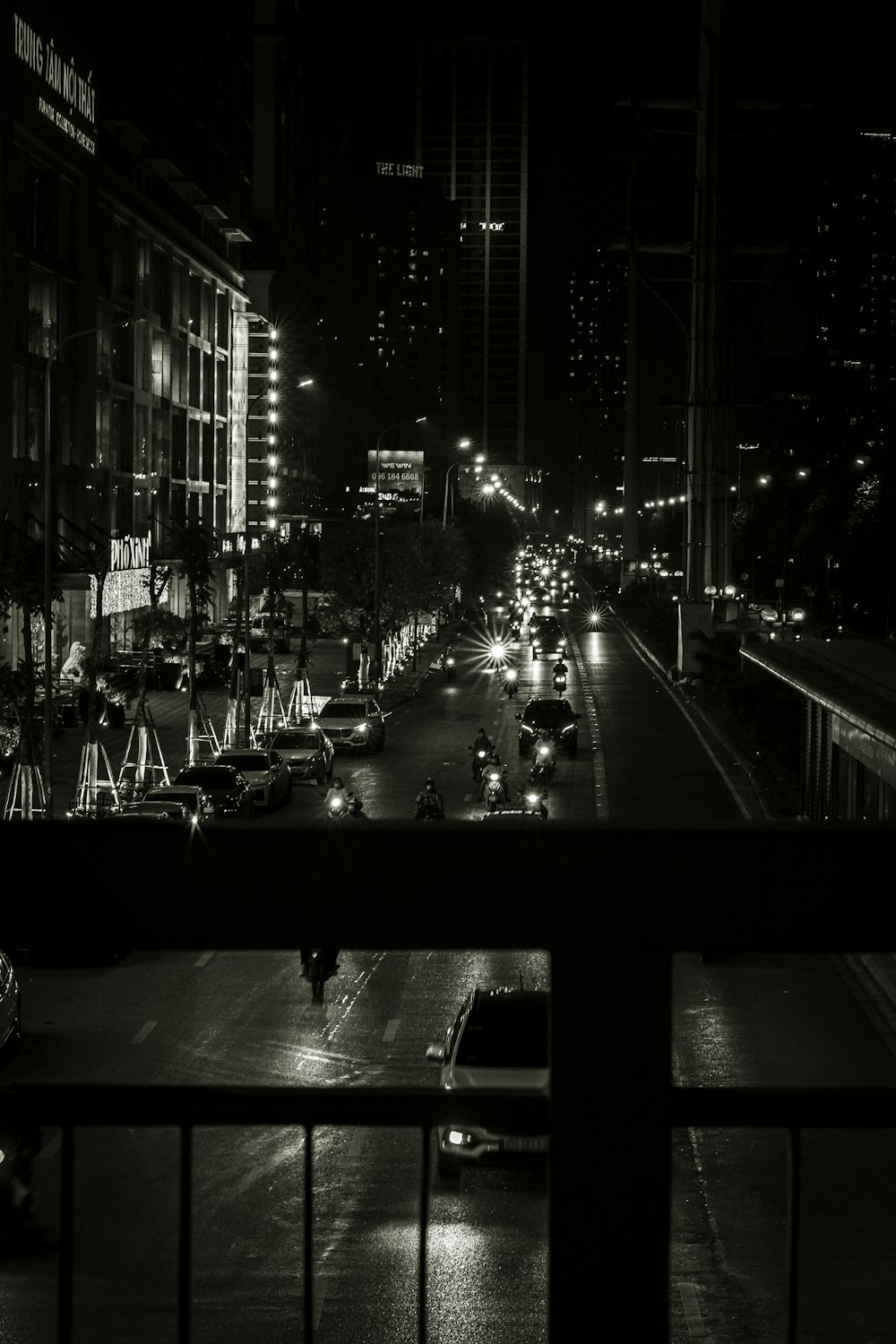 a black and white photo of a city street at night