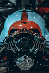 Close-up of a sleek custom motorcycle engine gleaming under workshop lights.