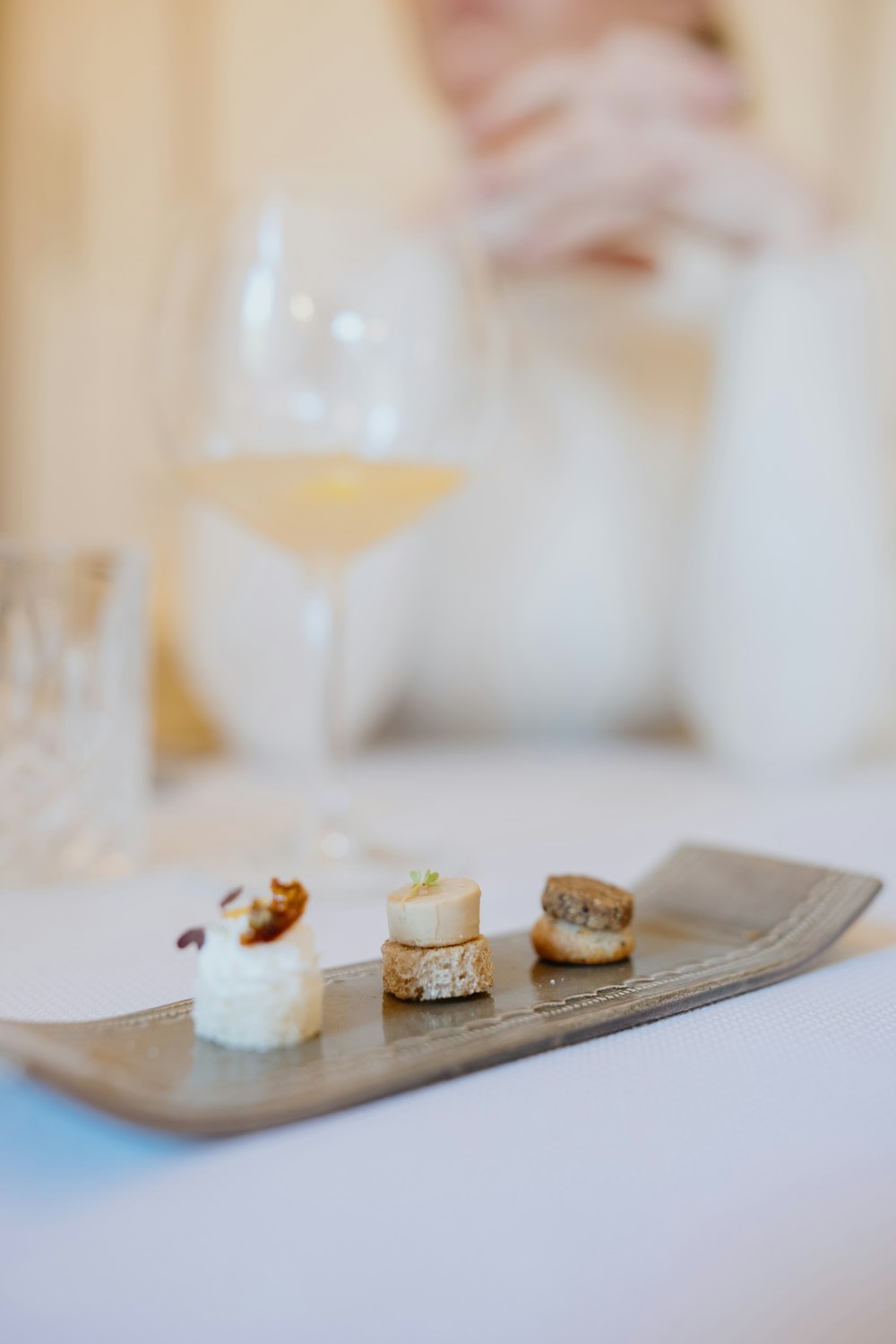 a plate of food and a glass of wine on a table