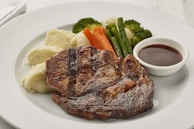 a white plate topped with meat and veggies