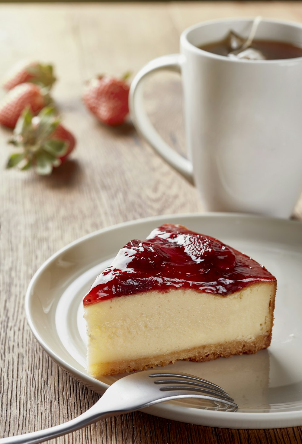 a piece of cheesecake on a plate with a fork