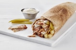 A close-up of a delicious shawarma wrap with fresh ingredients.