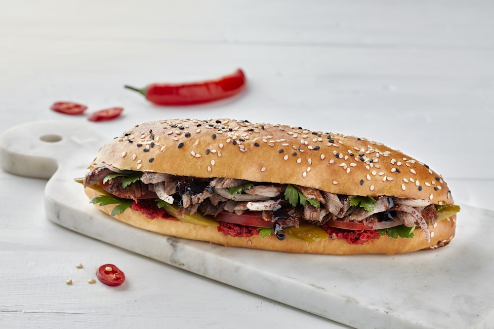 a large sandwich with meat, lettuce and tomatoes