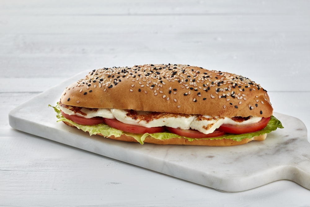 a large sandwich with lettuce, tomato and cheese