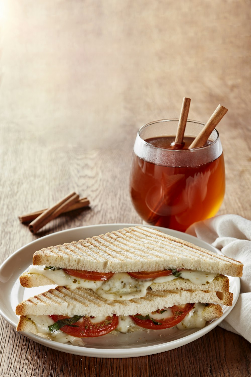 a white plate topped with a cut in half sandwich