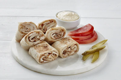 Freshly rolled zinger shawarma wrapped in warm flatbread ready to eat.