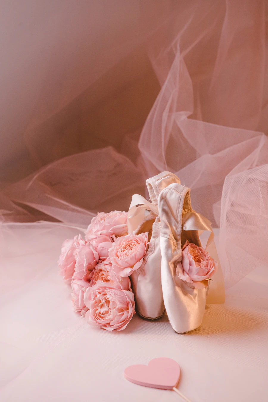 Pink pointe shoes with a bouquet of roses