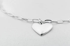 a silver heart charm on a silver chain
