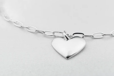 a silver heart charm on a silver chain