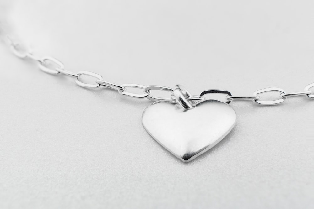 a silver heart charm on a silver chain