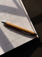 a pen sitting on top of a piece of paper