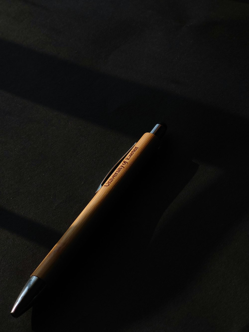 a pen sitting on top of a black surface