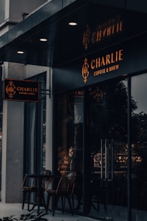 Customers enjoying coffee and conversation in the bright, modern space of Charlone Club Charlone.