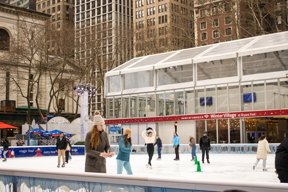 a group of people skating on an ice rink