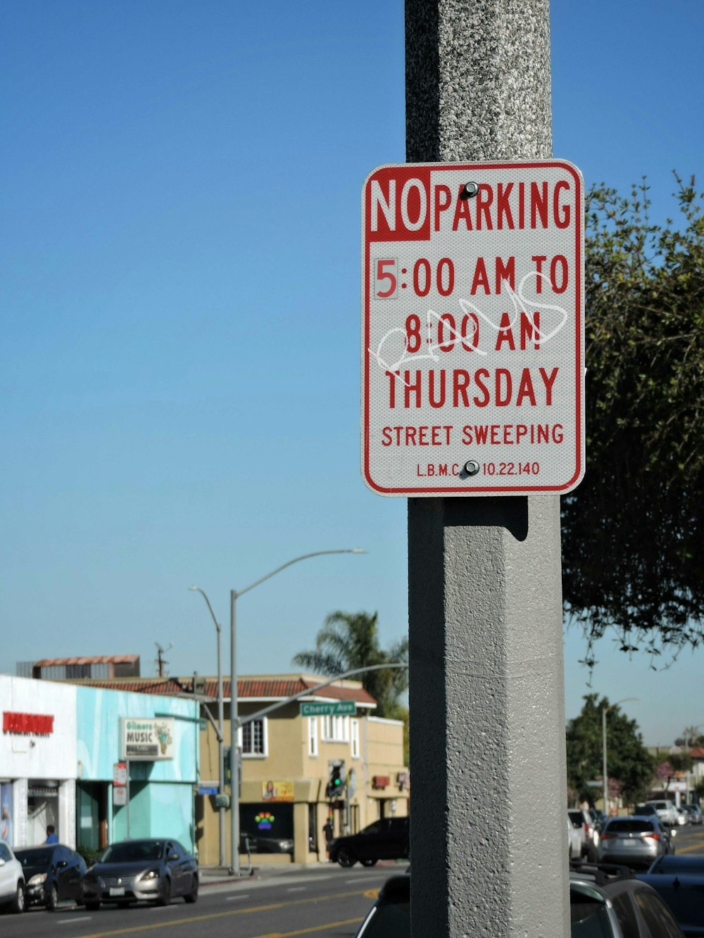 a no parking sign on a pole on a city street