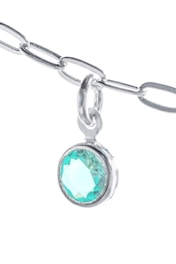A close-up view of a silver chain with a pendant featuring a round, turquoise-colored gemstone. The chain and pendant are set against a bright white background, highlighting the shine and intricate details of the metal links. The gemstone displays a faceted cut, reflecting light and creating a sparkling effect.