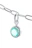 Close-up of a silver pendant with a sparkling natural Swat gemstone on a beige marble background.