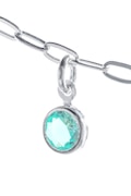 A close-up view of a silver chain with a pendant featuring a round, turquoise-colored gemstone. The chain and pendant are set against a bright white background, highlighting the shine and intricate details of the metal links. The gemstone displays a faceted cut, reflecting light and creating a sparkling effect.