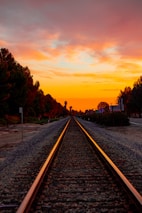 Railway infrastructure stretching into the horizon at sunset.
