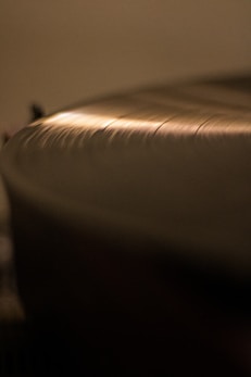 Elegant vinyl record with a warm golden glow reflecting softly.