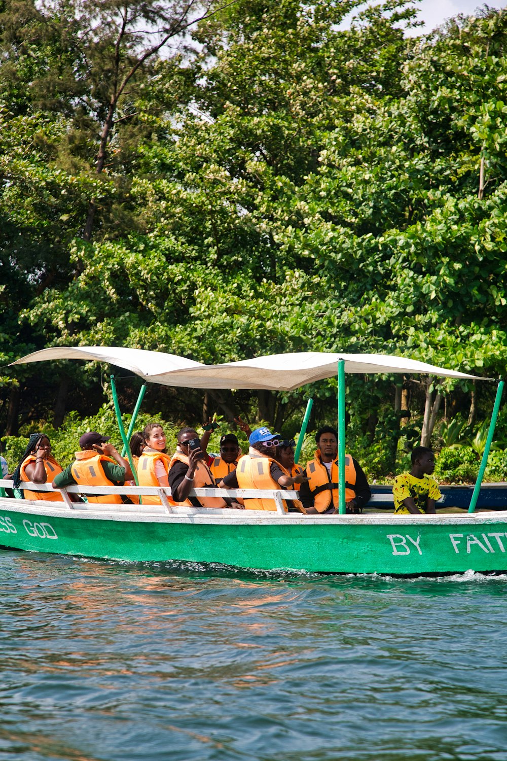a group of people riding on a green boat
