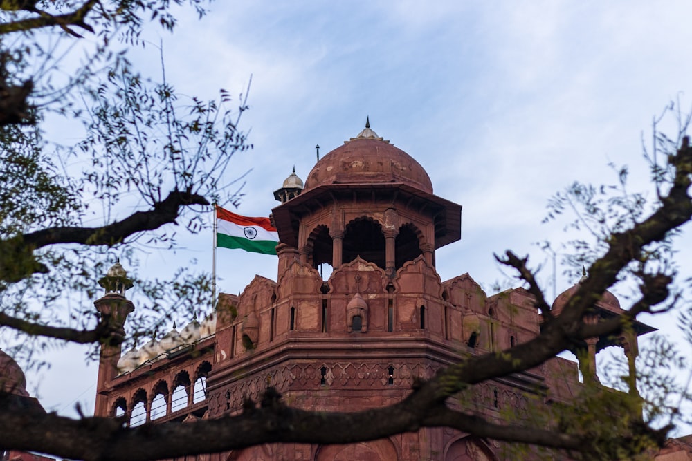 a tall building with a flag on top of it